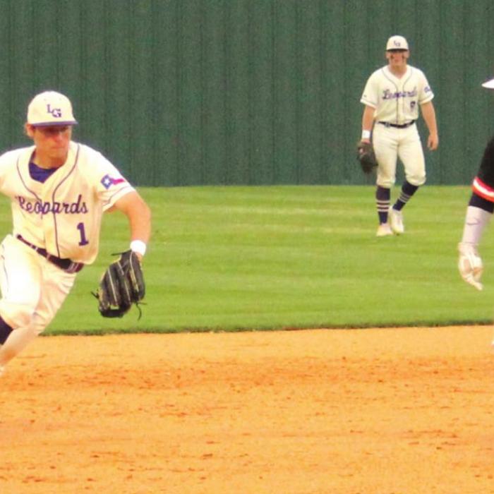 La Grange’s Wyatt Wick backhands a grounder as a Smithville runner dashes from second to third in Thursday’s Game 2. Photos by Jeff Wick
