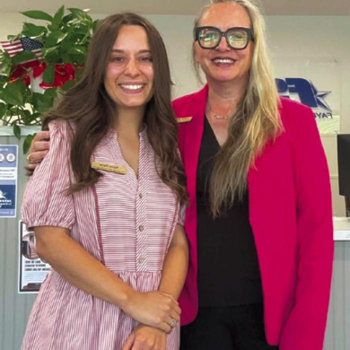 Fayette Savings Bank's Nicole and Sarah posing in pink to honor Dolly Parton.