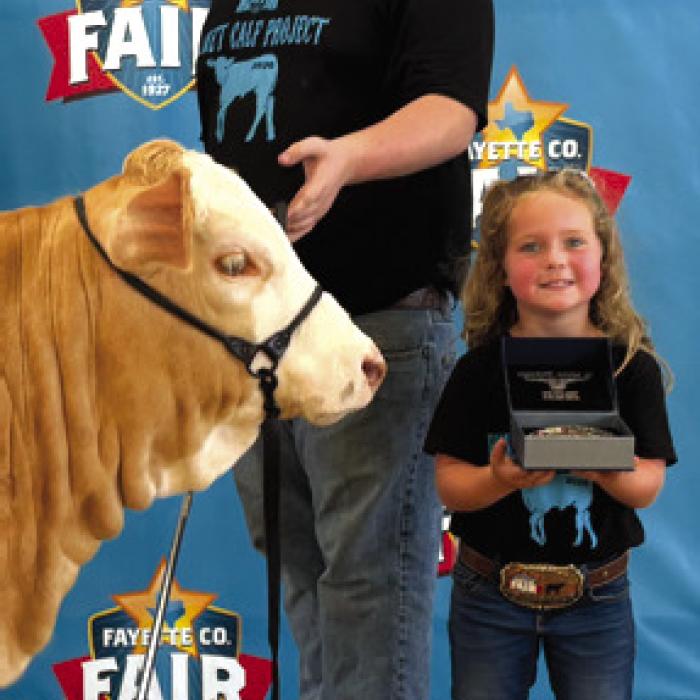 Sabrina the calf, Rilan Karisch and Grand Champion winner Riley Patterson.