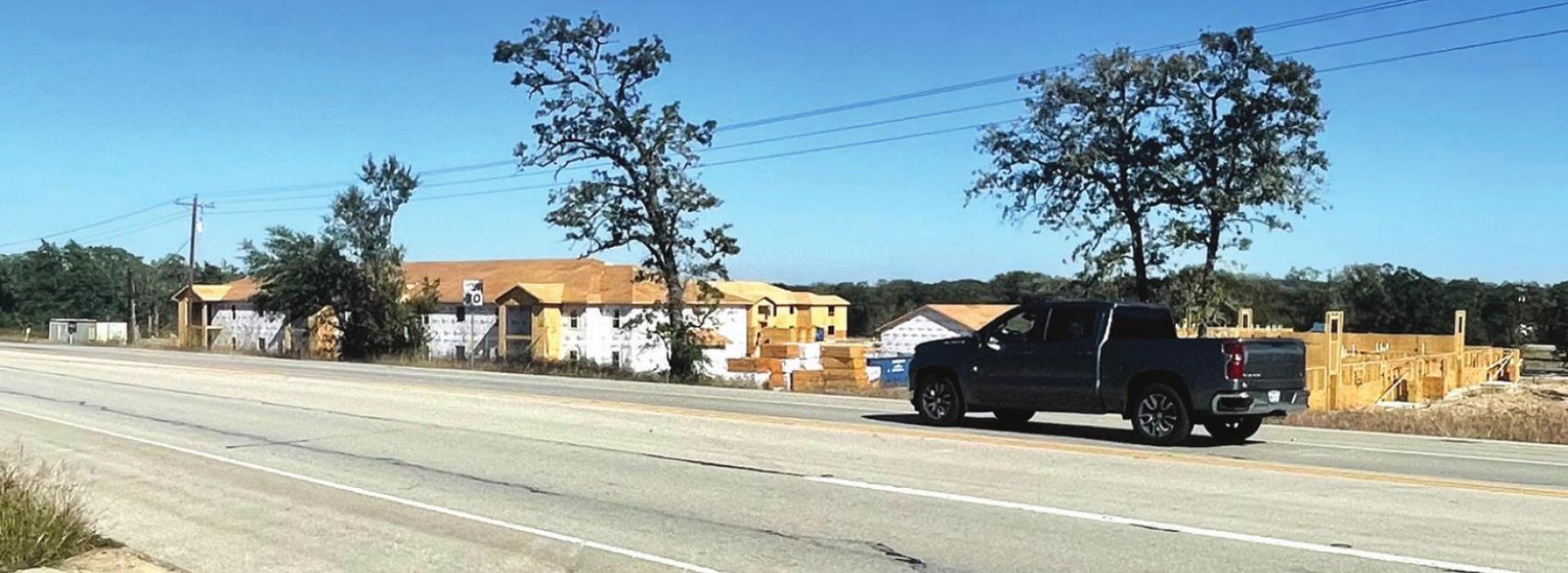 A pickup drives past the construction site for the La Grange Springs apartment complex on US 77 on the north side of La Grange. Texas Department of Transportation plans to expand US 77 into a four lane divided highway through most of Fayette County north of La Grange. Photo by Andy Behlen
