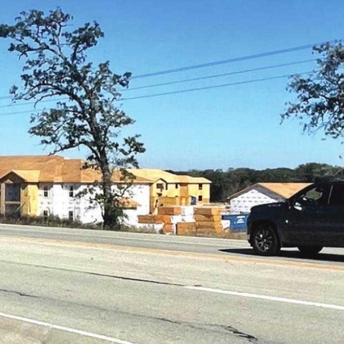 A pickup drives past the construction site for the La Grange Springs apartment complex on US 77 on the north side of La Grange. Texas Department of Transportation plans to expand US 77 into a four lane divided highway through most of Fayette County north of La Grange. Photo by Andy Behlen