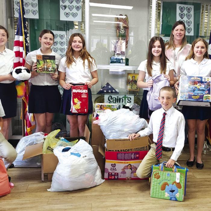 During Catholic Schools Week, students perform community service. St. Michael Catholic School in Weimar was visited by Kristi Bauer from CASA of Bastrop, Fayette &amp; Lee Counties to talk about children in need. St. Michael students collected games, toys, diapers, and other needed items. Pictured are (front, from left) Chandler Williams and Cade Wessels, (back) Andie Melnar, Sarah Jane Berger, Kendall Jahn, Ella Herzik, CASA Executive Director, Kristi Bauer, Olivia Elstner, and Emily Wied.