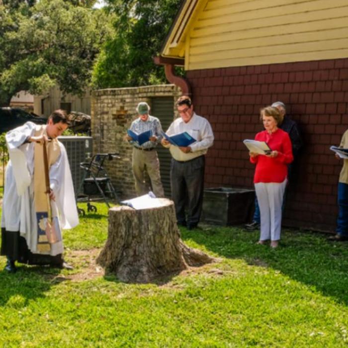 Fr. Eric Hungerford breaks the first shovel-full of ground at the site preschool expansion for St. James Episcopal Church in La Grange last Monday. Photo by Andy Behlen