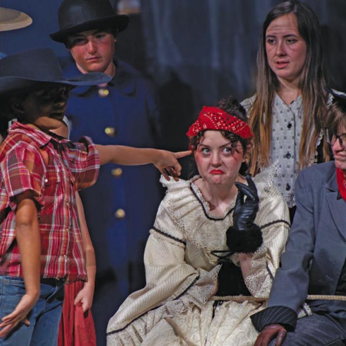 Annie McCain, who played the orphan Tiger, points out the villians, Aubrie Plowman and Lilly Mouton, seated, as they realize they have been caught.