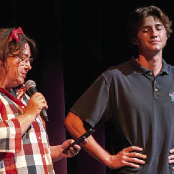 Deacon Wick, right, the student director, and Lucy Carr, the play’s adult mentor, talk to the crowd before Friday’s show.