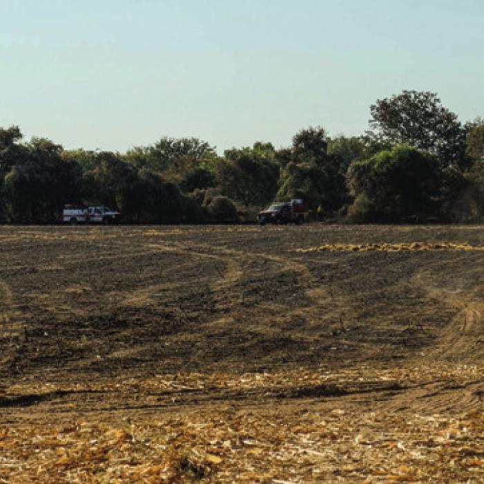 Texas Forest Service personnel mop up the remnants of the Amaze Fire, which burned about 63 acres in a corn field near the Fayette-Bastrop County Line on Tuesday. Photo by Andy Behlen