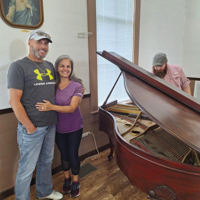 Roger and Vikki Warnken recently donated a piano to the Freyburg Methodust Church. The photo above their heads was donated to the church in the early years by Roger’s Great Aunt Mary Warnken.