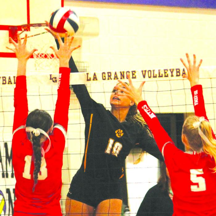La Grange’s Camille Gonzalez goes up for a spike against the defense of a pair of Bellville player Tuesday. Gonzalez led the Lady Leps with five kills. Photo by Jeff Wick