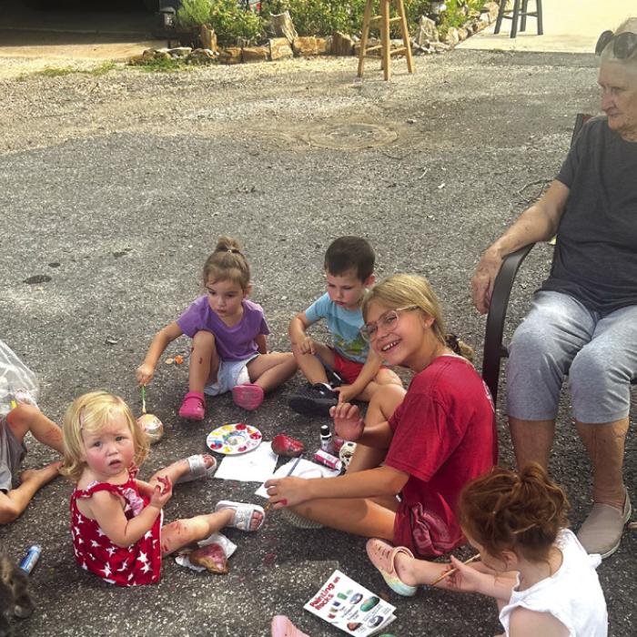 Local kiddos do an art project under the watchful eye of Tracy Svrcek.