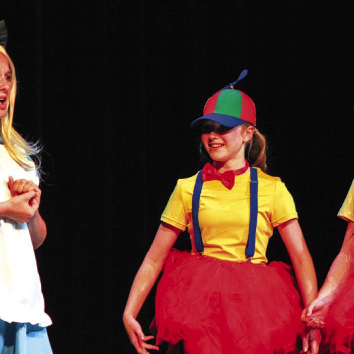 The La Grange 6th grade theater class under the direction of Erin Oppermann performed “Alice in Wonderland” at the Performing Arts Center Monday. From left to right is Ally Canada as Alice and Langley Murphy and Ruby Freedman as Tweedle-Dee and Tweedle-Dum. Photo by Meadow Taylor-Marklin