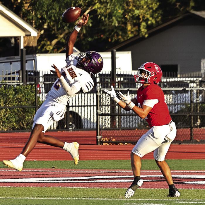 La Grange’s Howard “Skip” Holmes leaps high to bat away this pass attempt by Columbus during Friday’s game. Photo by Darrell D. Gest