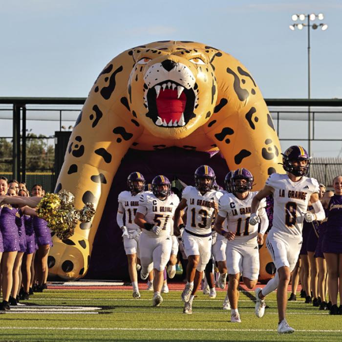 The La Grange Leopards run out of the tunnel at the start of their game Friday in Columbus. Photo by Darrell D. Gest