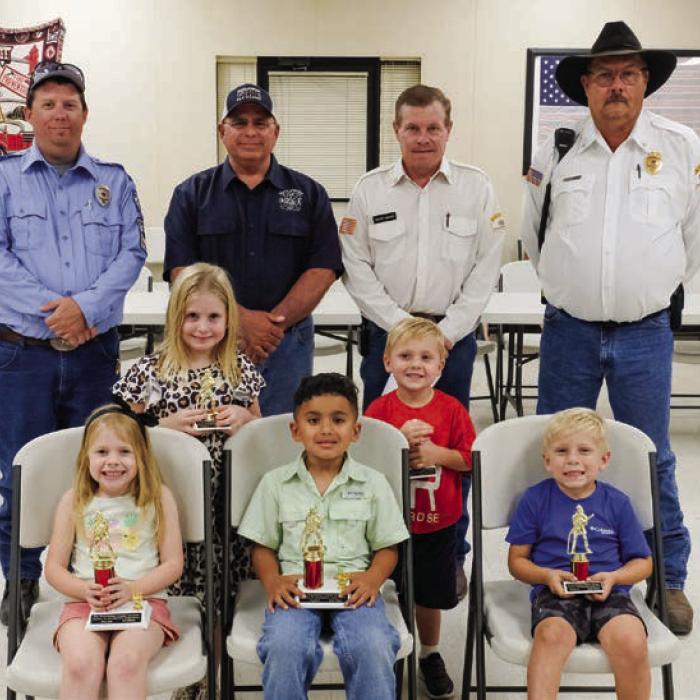Winners in the Kindergarten Division (Pre-k and Kindergarden) went to (front, from left) First Place - Allie Neiser, Second Place - Emmanuel De Arcis, Third Place - Leighton Woods, (middle row) Honorable Mention - Paisley Guentert, Luke Hudec and (not pictured) Lochlan Stewart. Also pictured are (back row) Fayette County Firefighters Andrew Baker of Muldoon VFD, Quentin Riche of Schulenburg VFD, Calvin Krause of Round Top-Warrenton VFD and Keith Burcalow of Round Top-Warrenton VFD.