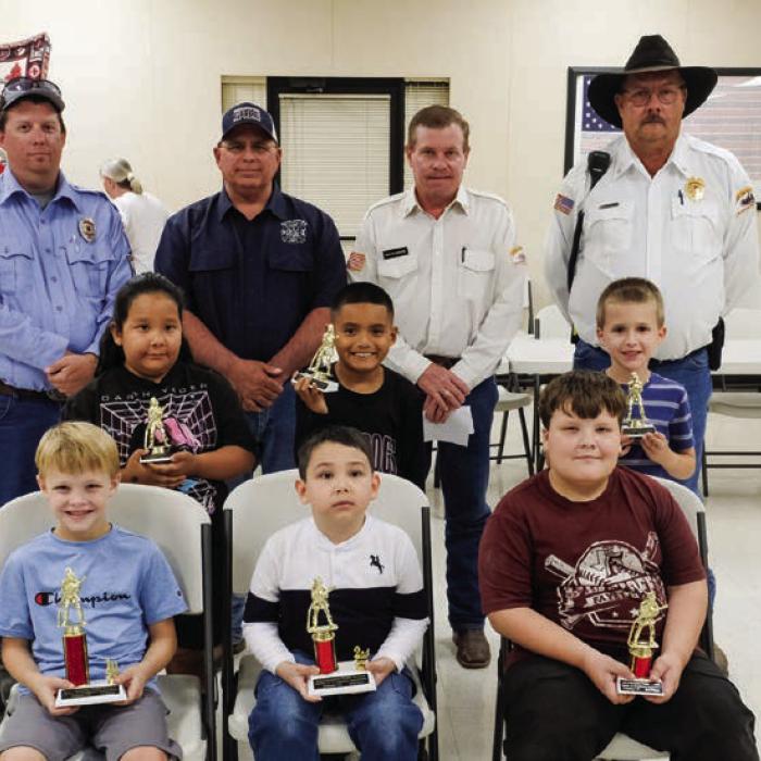 Winners in the Primary Division (Grades 1 and 2) went to (front, from left) First Place - Sutton Mozisek, Second Place - Ryker Demel, Third Place - Joseph Nigh, (middle row) Honorable Mention - Alissa Romero, Bryan Toro and Tycen Mendel. Also pictured are (back row) Fayette County Firefighters Andrew Baker of Muldoon VFD, Quentin Riche of Schulenburg VFD, Calvin Krause of Round Top-Warrenton VFD and Keith Burcalow of Round Top-Warrenton VFD.