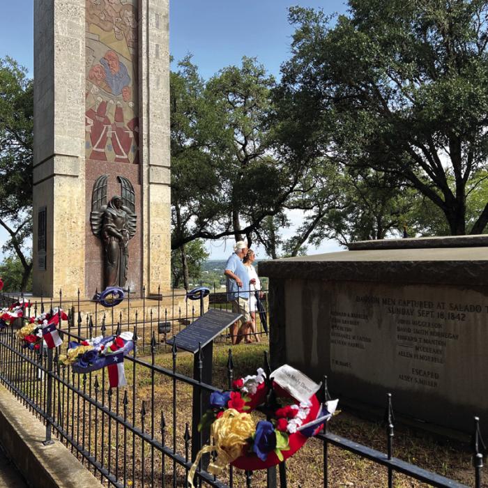 Visitors pause at the grave of Republic of Texas soldiers buried at Monument Hill. There final resting place is always adorned with wreaths on Texas Heroes Day.