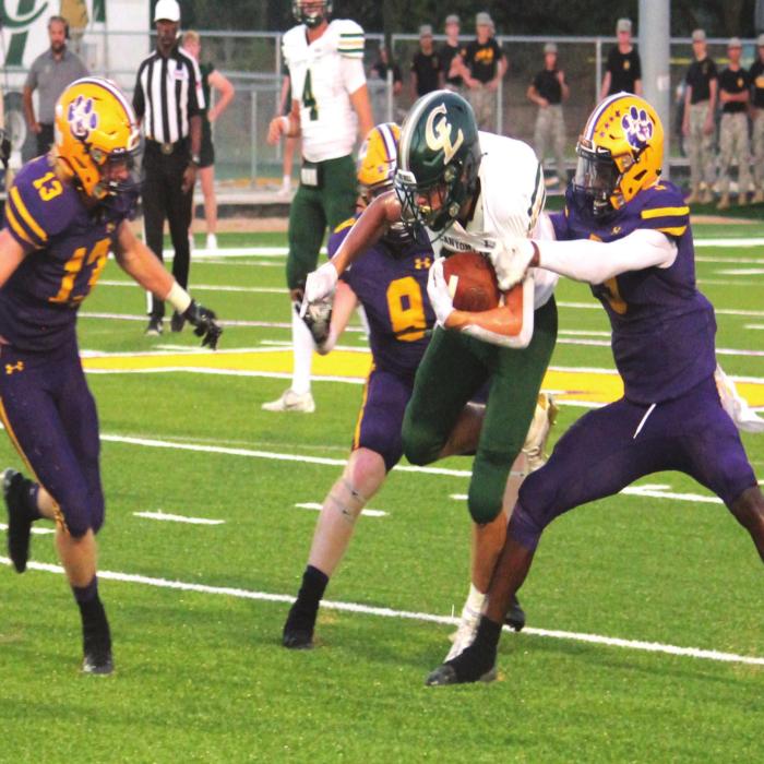 La Grange’s Justin Lewis (13), Ryder Imhoff (8) and C.J. Davis (right) converge on this Canyon Lake ballcarrier Friday. Photo by Jeff Wick