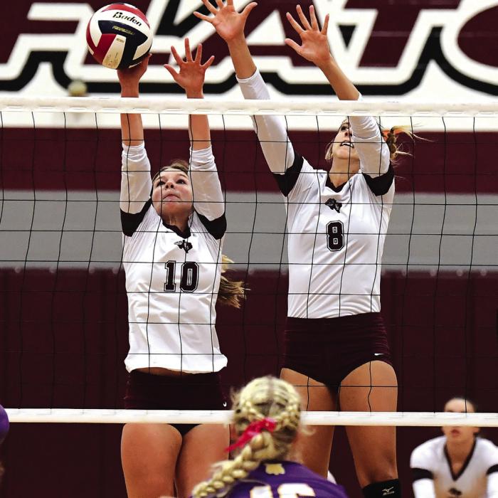 Katie Templeton (#10) blocks a Lady Wildcat hit for the Flatonia Lady Bulldogs in Tuesday night’s district matchup with Weimar. Also shown is Braidy Fike (#8). Photo by Stephanie Steinhauser