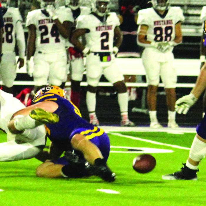 La Grange’s Anthony Weikel, center, tackles the Madisonville quarterback and forces a fumble which was picked up by Lep Cooper Imhoff, right. That turnover set up a Leps touchdown that would give them a brief 7-0 lead Thursday. Photo by Jeff Wick