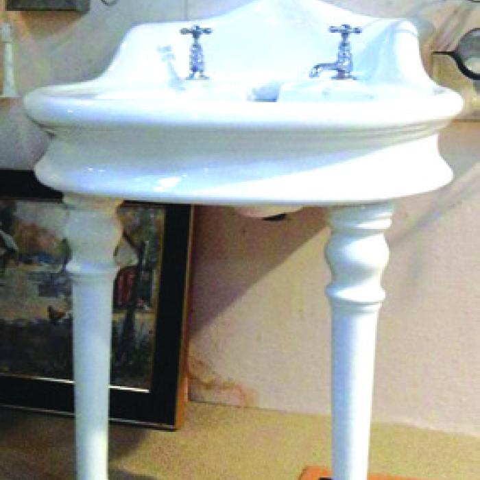 Small earthenware bath sink on legs.