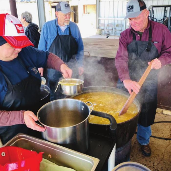 Pictured are Paula Urban and her dad Lawrence Urban, and Dennis Neisner. They are dishing up the soup made from a family recipe for the Ellinger Chamber of Commerce Fundraiser.