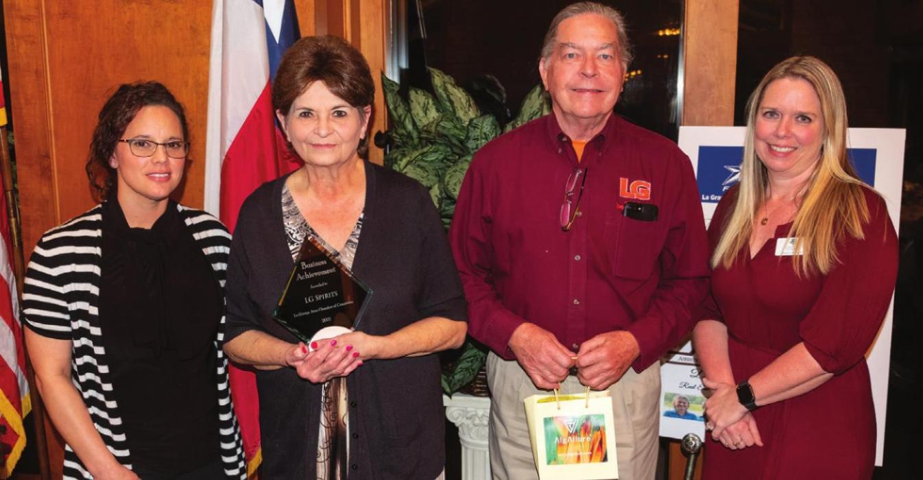 The La Grange Chamber of Commerce Business Achievement Award with to Grace Pulkrabek and Larry Glass, owners of LG Spirits. Presenting the award were Chamber Operations Director Jamie Fabre (left) and Chamber Board Chairwoman Mindy Davis (right).