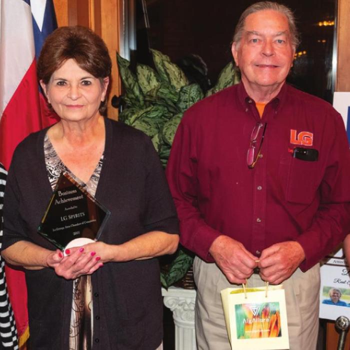 The La Grange Chamber of Commerce Business Achievement Award with to Grace Pulkrabek and Larry Glass, owners of LG Spirits. Presenting the award were Chamber Operations Director Jamie Fabre (left) and Chamber Board Chairwoman Mindy Davis (right).