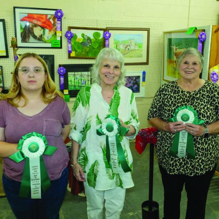 BEST OF THE FINE ARTS DEPARTMENT Pictured (from left) are Autumn Wolf - 13 to 17 year olds - “A Girl with Her Horse,” Ina Faye Tilley - 18 and above - “Purple Irises with Black Iron Rod Fence,” and Kathy Sauer - 70 and above - “Longhorn Cow and Calf.” Not pictured was Grace Neuman - 8 to 12 year olds - “Anime.”