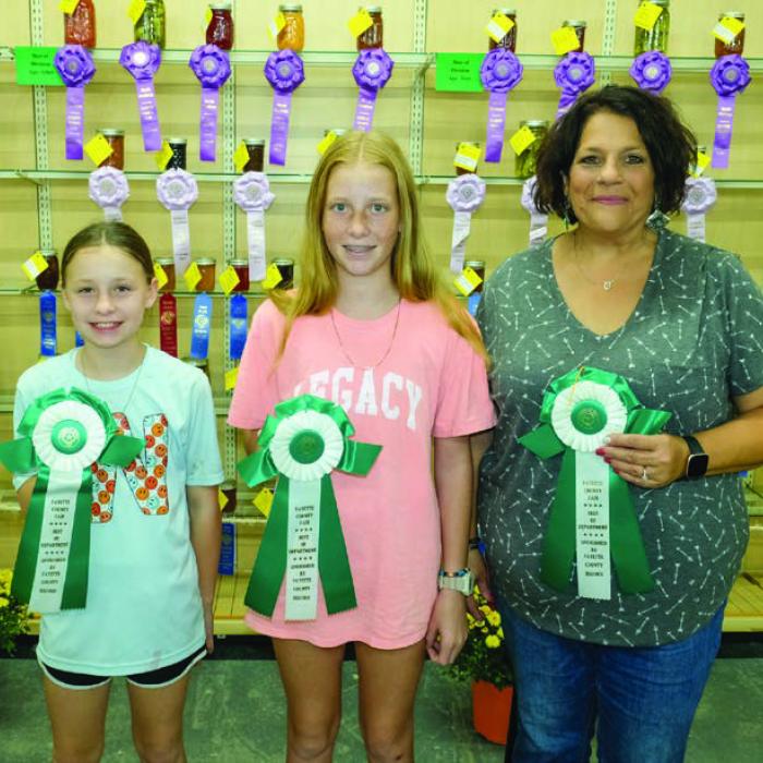 BEST OF THE CANNING AND PRESERVING DEPARTMENT Pictured (from left) are Kensi Berger - 8 to 12 year olds - squash, Morgan Nelius - 13 to 17 year olds - strawberry fig jam, and Connie Beseda - 18 and above - picante sauce. Not pictured was Angeline Srubar - 70 and above - picante sauce.