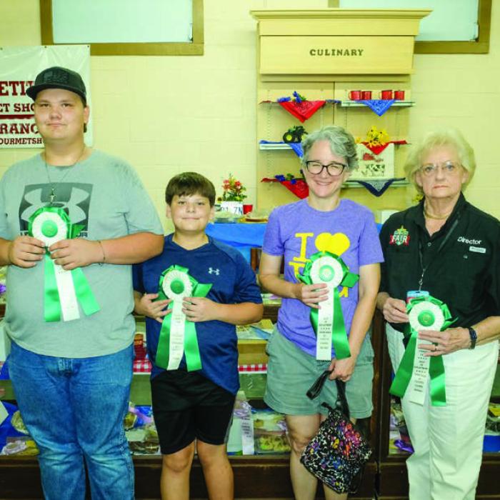 BEST OF THE CULINARY DEPARTMENT Pictured (from left) are Jacob Nigh - 13 to 17 year olds - German chocolate cupcakes, Joshua Nigh - 8-12 year olds - Dr. Pepper cupcakes, Monica Smith - 18 and above - peanut brittle, and Glenna Laffey - 70 and above - carrot cake.