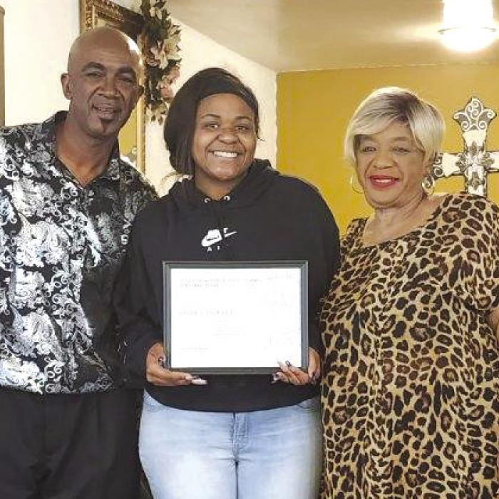 Pictured with Powell (center) is James R. Carlton and Dorothy Carlton, honoree family members.