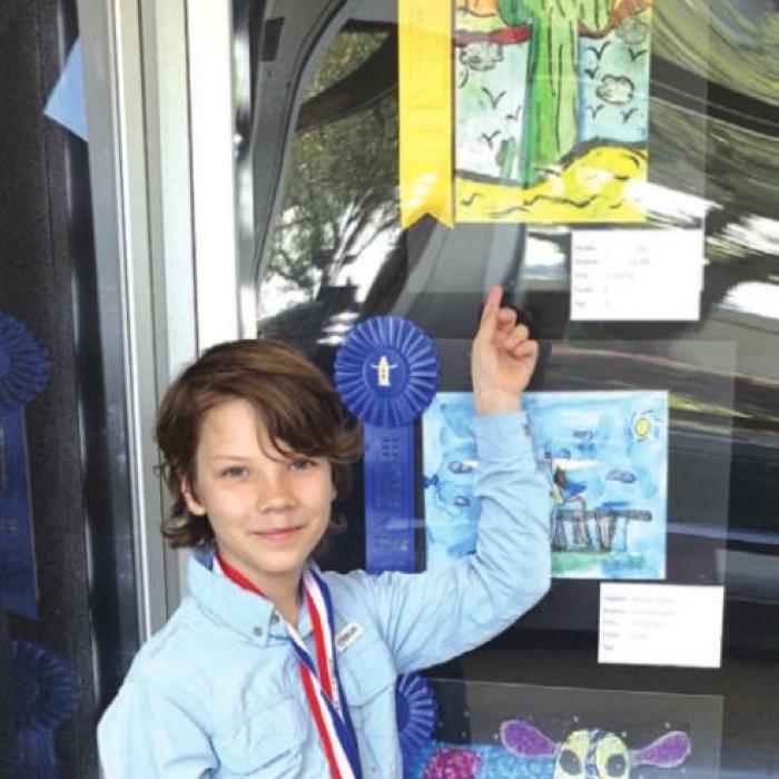 Mitchel Mings points out his winning artwork.