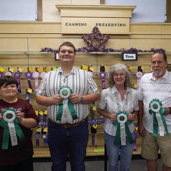 BEST OF THE CANNING AND PRESERVING DEPARTMENT From left, best of department in the child division went to Joseph Nigh for grape jelly; best of department in the teen division went to Jacob Nigh for marina sauce; best of department in the adult division went to Cathy Gau for pickled squash; best of department in the senior division went to Willie Gillie for tomato lemon jelly.