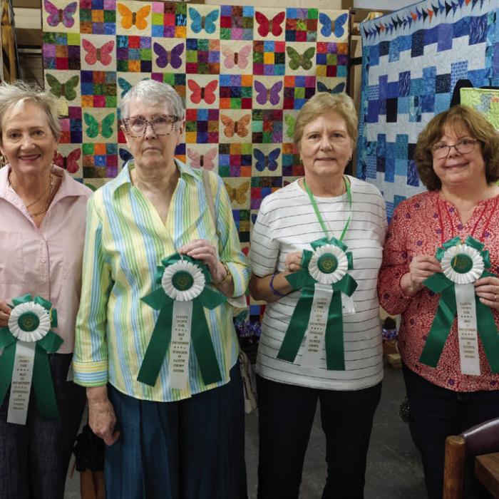BEST OF THE QUILTING DEPARTMENT From left, best of department in the senior division went to Deborah Kainer; best of department in the professional division went to Leoni Shaw; best of department in the group division went to the Colorado Quilt Guild, represented by Marian Tajchman and Dawn Allison. Not pictured was Sandy Courrier, who won best of department in the adult division.
