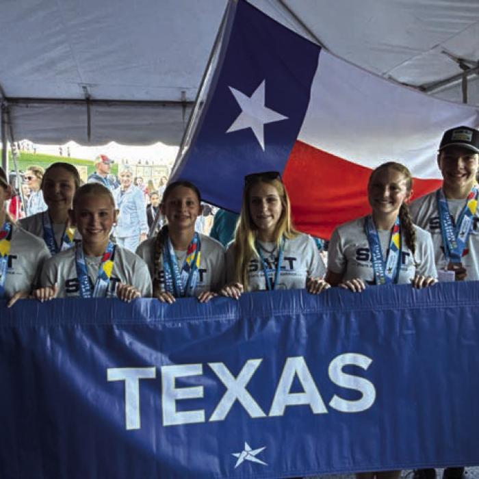 Several of the local swimmers are shown here participating in the opening ceremonies of the State Games of America in Pennsylvania last week.