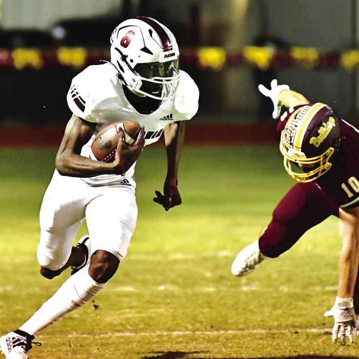 Flatonia’s Jaidyn Guyton breaks a tackle and runs 98 yards for a touchdown Friday night when the Flatonia Bulldogs traveled to Thorndale. Photo by Stephanie Steinhauser