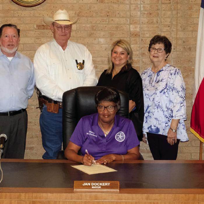 La Grange Mayor Jan Dockery (seated) signed a proclamation designating Oct. 24 as World Polio Day. On hand for the signing were representatives of the La Grange Rotary Club. Rotary Club International is a founding member of the Global Polio Eradication Initiative. Pictured are (back, from left) Rotarians Leonard Nuckolls, La Grange Police Chief David Gilbreath, Tish Muniz and Janet Moerbe. Staff photo by Andy Behlen