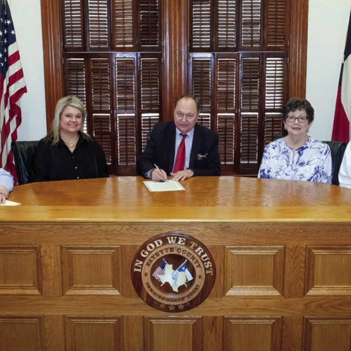 Fayette County Judge Dan Mueller signed a proclamation designating Oct. 24 as World Polio Day in Fayette County. On hand for the signing were representatives of the La Grange Rotary Club. The proclamation stated that polio cases have declined by 99.9 percent worldwide since 1988, thanks in part to the efforts of Rotary International. Pictured are (from left) Rotarians Leonard Nuckolls, Tish Muniz, County Judge Dan Mueller, Janet Moerbe and La Grange Police Chief David Gilbreath. Staff photo by Andy Behlen
