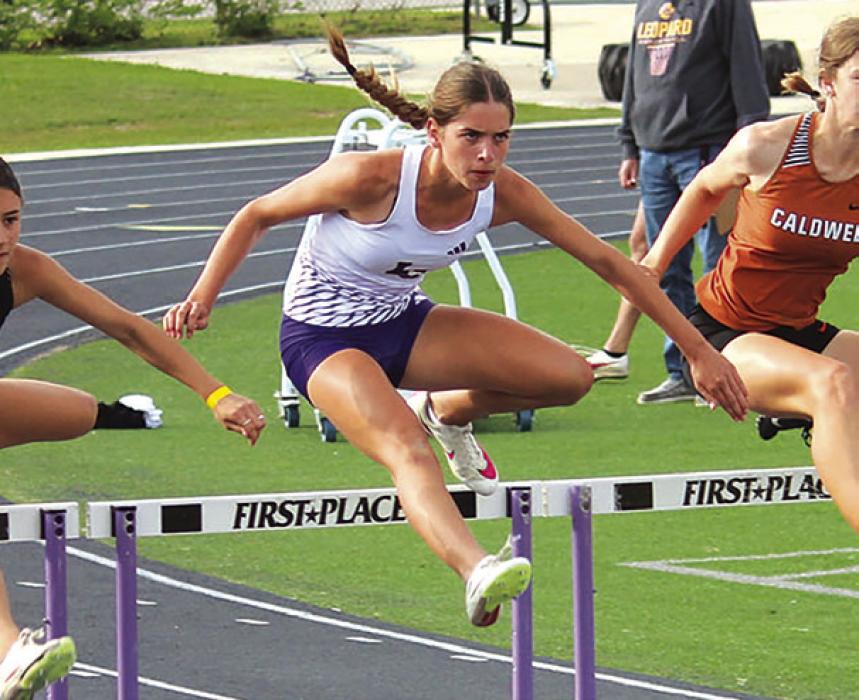 Macie Collier running the 100 hurdles at the area meet. Photo by Jeff Wick