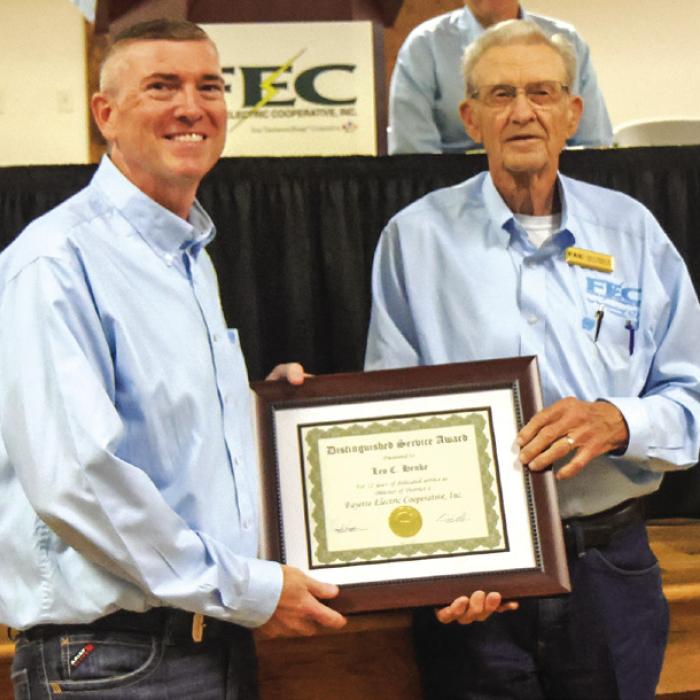 Leo C. Henke, director of District 4, also retired from the board of directors after serving for 22 years. Leo is pictured at right receiving a distinguished service award from General Manager/ CEO Doug Lambert.