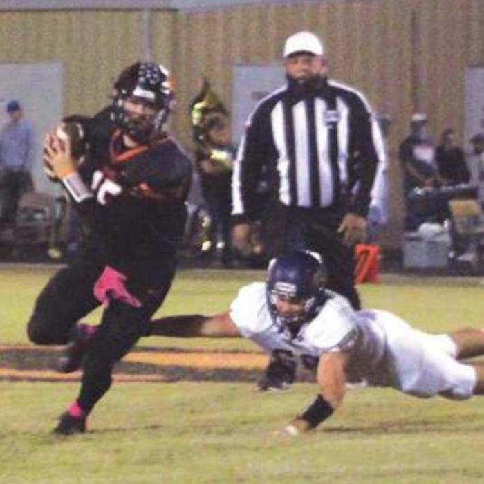 Schulenburg quarterback Brett Janecek scrambles away from this Shiner defensive player Friday. Photo by Brian Pierson