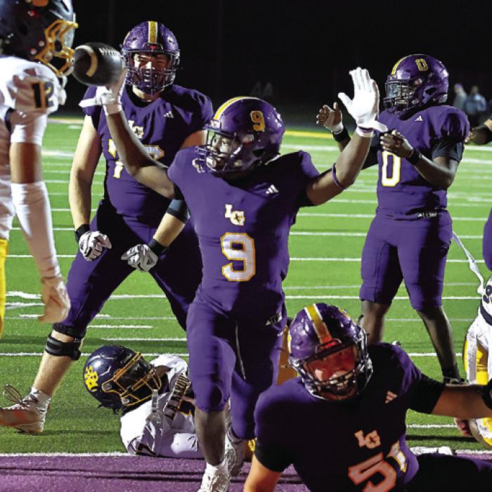 La Grange’s Dillan Johnson signals touchdown after his fifth score of the night late in the fourth quarter clinched the win Friday for the Leps. Photo by Darrell D. Gest