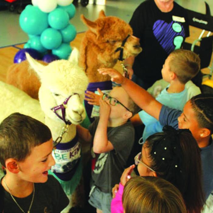 September is National Suicide Prevention Awareness Month, and Wednesday Loretta Hajovsky brought her alpacas to La Grange Elementary for a special pro-kindness, anti-bullying presentation that included time for the kids to hug and interact with the fluffy animals. Pancho is the brown alpaca and Lefty is the white one. Hajovsky donates her services to the school for the event as has done so for several years. Photo by Jeff Wick