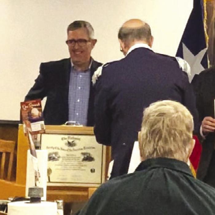 The SAR induction ceremony, left to right: Jack Muggli, registrar/ genealogist, Alex Thorne, chapter President, Tom Jackson, compatriot sponsor of new SAR inductee, Rotter. It is tradition to remove the SAR rosette pin from the President and pin it on the new SAR member.