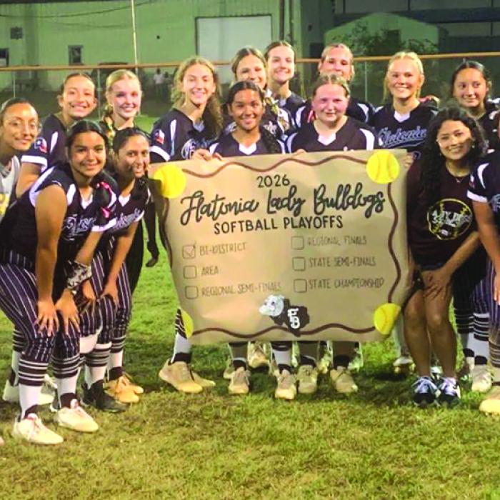 The members of the Flatonia softball team celebrate after Friday’s bi-district victory.