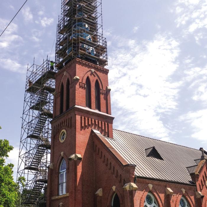 Workers with Cadillac Roofing of New Braunfels are clearly not afraid of heights. After a rain day on Tuesday, they were back to work Wednesday replacing the copper roof on the High Hill Church steeple. Photo by Andy Behlen