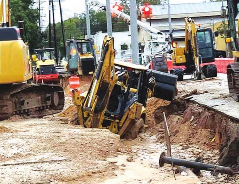 This backhoe was sunk in mud at the ongoing construction at the Beefhead Ditch area of La Grange. Photo courtesy of Frank Menefee