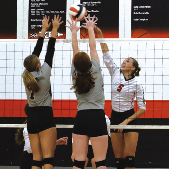 Schulenburg’s Brooke Redding battles at the net against a pair of Industrial players in Friday’s home match. Photo by Audrey Kristynik