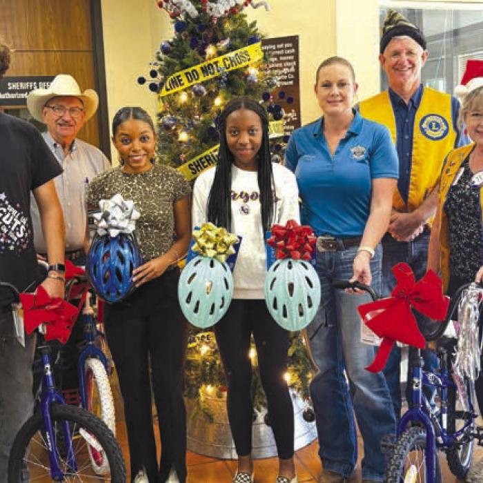 The La Grange Leo Club donated four bicycles with helmets to the Deputy Santa Program. Pictured from left to right are Natalia Soto, Mitchell Cervantez, Chief Deputy Randy Noviskie, Diamond McKenzie, Kaylee Holmes, Sgt. Angela LaLa, Michael Ahart, Diana Wilson, and Devante McKenzie.
