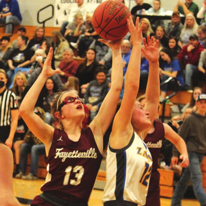 Fayetteville’s Brooklyn Jaeger jumps for a rebound in Friday’s regional semifinal game. She scored 29. Photos by Jeff Wick