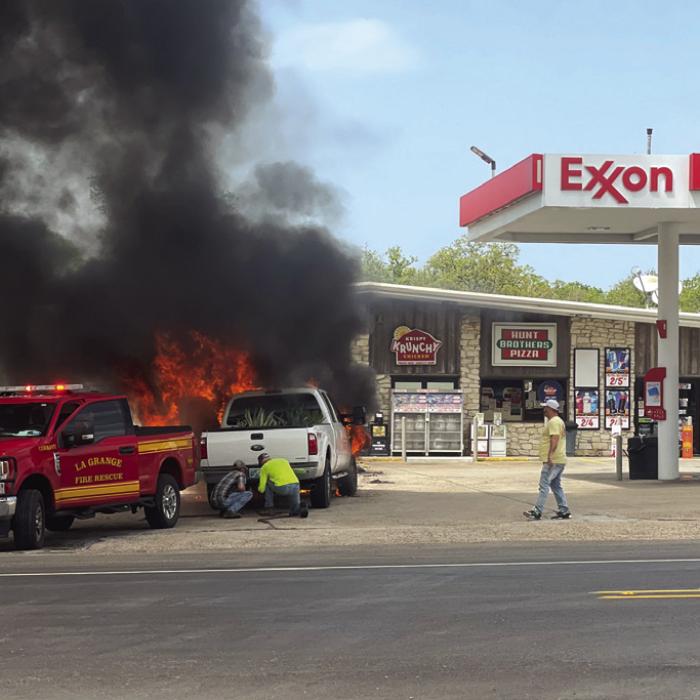 A shot of Monday’s fire after the burning truck had been pulled away from the store by La Grange Fire Chief Frank Menefee with the help of local carpenter Justin Coufal and other bystanders to protect the building. Photo by Andy Behlen